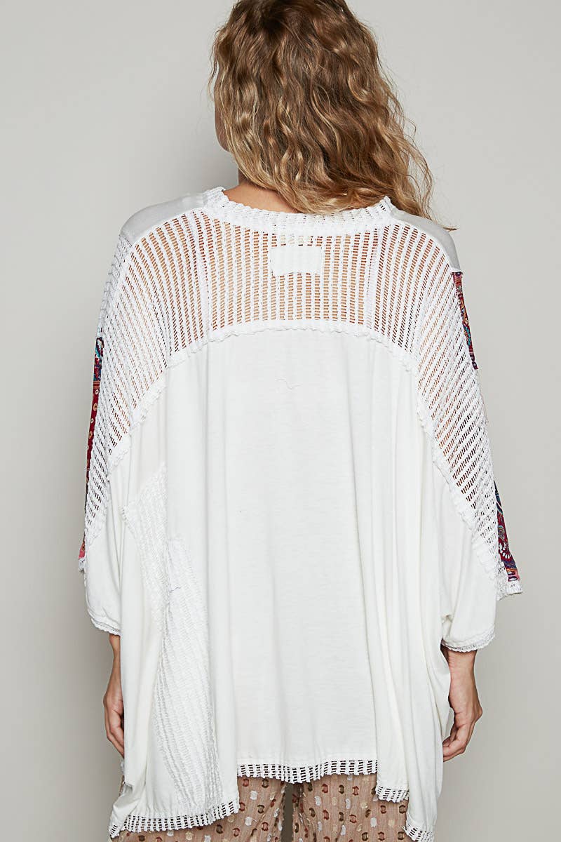 V-neck drop shoulder print fabric contrast knit top.